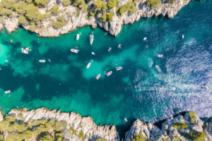 Turquoise calanque near Marseille, limestone cliffs and boats